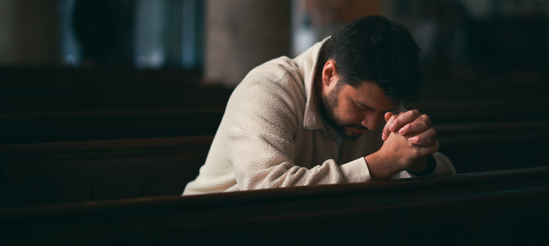 Person in deep prayer at church